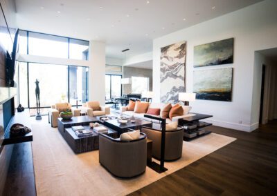 Modern living room with contemporary furniture and large windows.