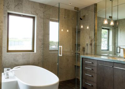 Modern bathroom with free-standing tub, glass shower stall, and a double vanity.